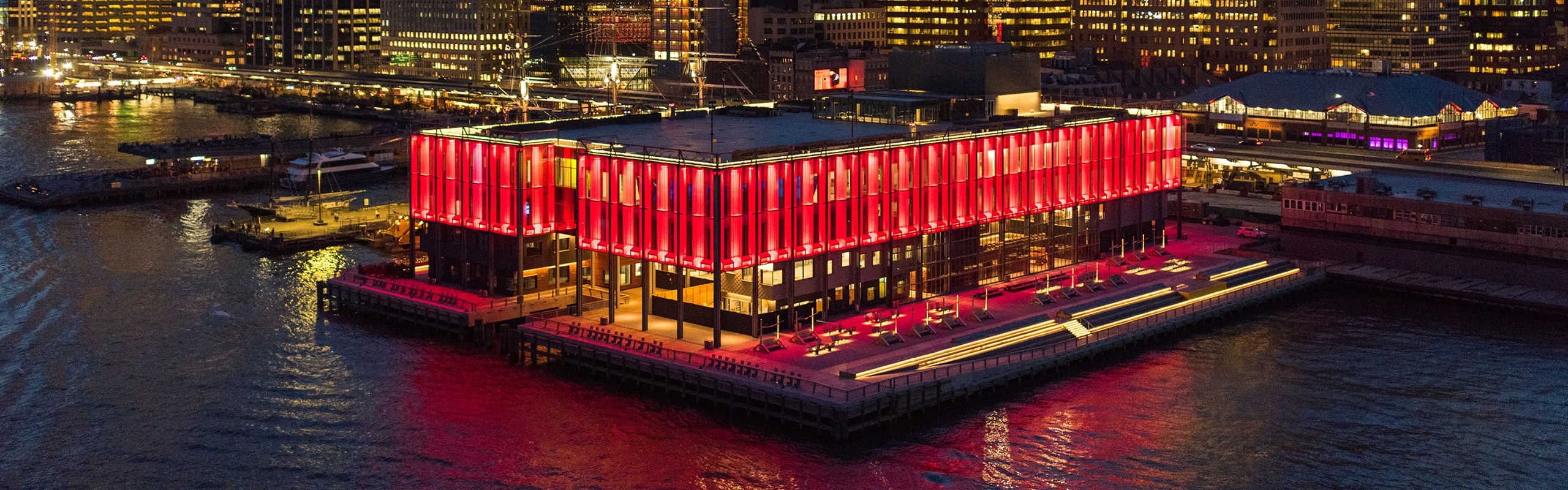 Pier 17 lit up in red lights